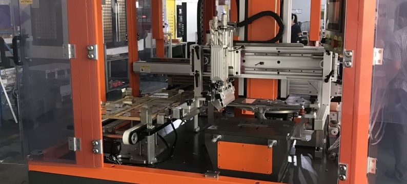 Servo-controlled turntable and servo systems where screen covers for mobile phones are printed.